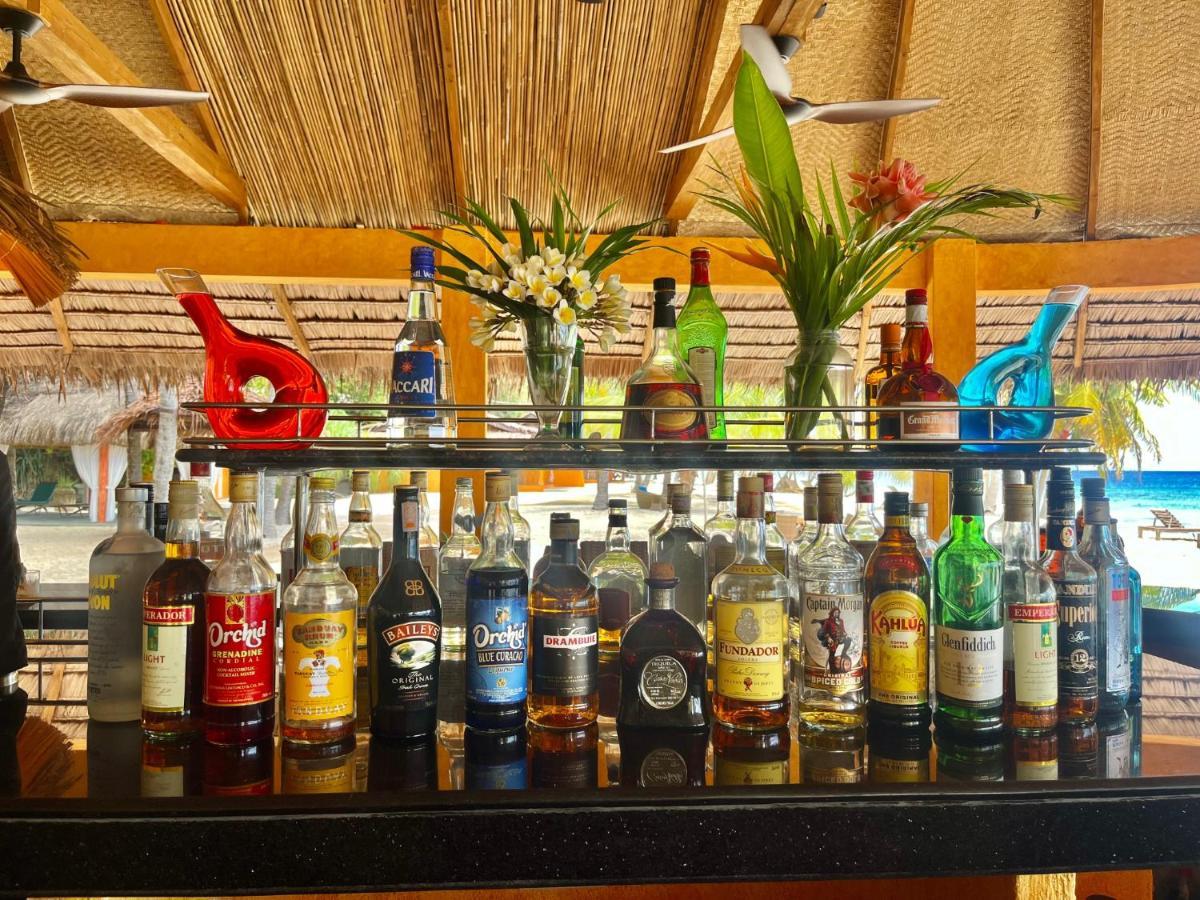 Coco Grove Beach Resort, Siquijor Island Экстерьер фото Rum bottles at a bar in the Caribbean